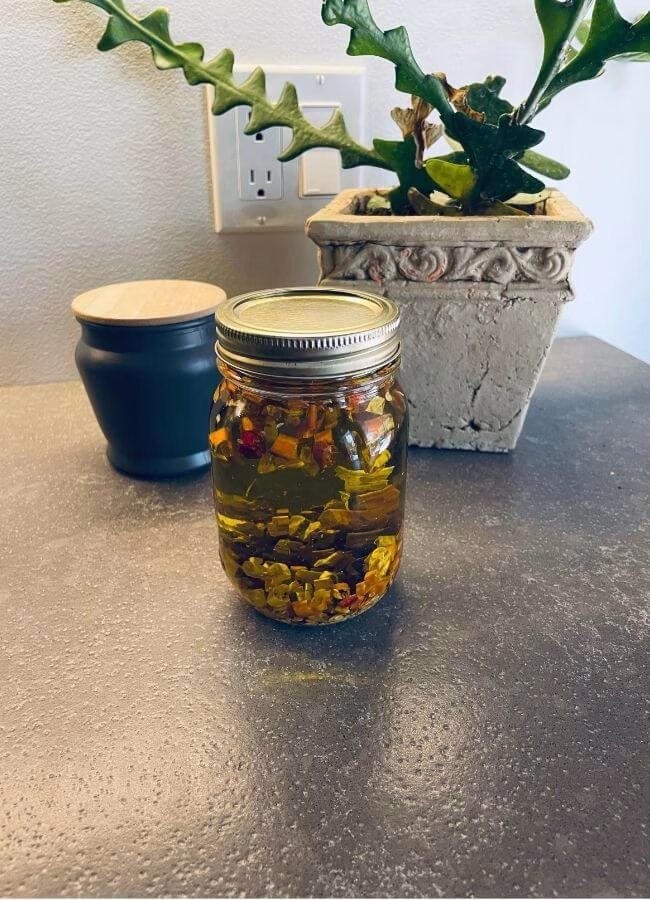 Homemade herb-infused Cayenne Pepper and Olive oil ready to use in natural body butters, balms and soap recipes.
